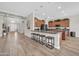 Open kitchen with bar seating, wood cabinets, and stainless steel appliances at 5542 W Big Oak St, Phoenix, AZ 85083