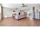 Bright and spacious living room featuring hardwood floors, comfortable seating, and multiple ceiling fans for optimal comfort at 5542 W Big Oak St, Phoenix, AZ 85083