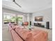 Spacious living room featuring a large sectional sofa, entertainment center, and bright natural light at 5542 W Big Oak St, Phoenix, AZ 85083