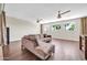 Bright living room with hardwood floors, ceiling fans, and large windows offering natural light and picturesque views at 5542 W Big Oak St, Phoenix, AZ 85083