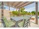 Charming outdoor dining area under a pergola, featuring comfortable seating and views of the pool at 5542 W Big Oak St, Phoenix, AZ 85083