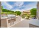 Outdoor kitchen area equipped with a built-in grill and countertop space, perfect for entertaining at 5542 W Big Oak St, Phoenix, AZ 85083