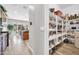 Spacious pantry with white shelving offers ample storage for all your kitchen essentials and keeps things organized at 5542 W Big Oak St, Phoenix, AZ 85083