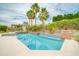 Sparkling pool featuring a Baja shelf, pergola, and lush landscaping with palm trees at 5542 W Big Oak St, Phoenix, AZ 85083