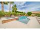 Resort-style pool and spa surrounded by lush tropical landscaping and a spacious patio area at 5542 W Big Oak St, Phoenix, AZ 85083