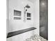 A modern shower showcasing white tile with a built-in bench and inset shelving at 5542 W Big Oak St, Phoenix, AZ 85083