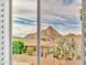 Mountain view from window with open shutters of surrounding homes and landscape at 5542 W Big Oak St, Phoenix, AZ 85083