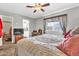 Cozy bedroom with a ceiling fan and comfortable bed at 6055 E Hannibal St, Mesa, AZ 85205