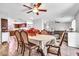 Traditional dining room boasts a ceiling fan and connects seamlessly to the kitchen and living area at 6055 E Hannibal St, Mesa, AZ 85205