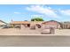 Single-story home with arched entry, desert landscaping, and driveway with basketball hoop at 6055 E Hannibal St, Mesa, AZ 85205