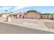 Single-story home with arched entry, two-car garage, and desert landscaping at 6055 E Hannibal St, Mesa, AZ 85205