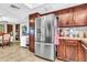 Bright kitchen with stainless steel refrigerator, wooden cabinets, and breakfast bar at 6055 E Hannibal St, Mesa, AZ 85205