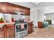 Well-equipped kitchen features modern stainless steel appliances and ample dark wood cabinet space at 6055 E Hannibal St, Mesa, AZ 85205