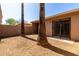 Compact backyard with block wall, palm trees and sliding glass door access to home at 611 E Colgate Dr, Tempe, AZ 85283