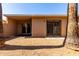 Small backyard featuring tan stucco wall and sliding glass door entry at 611 E Colgate Dr, Tempe, AZ 85283