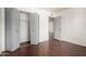 Bedroom featuring hardwood floors, neutral paint, and a closet with folding doors at 611 E Colgate Dr, Tempe, AZ 85283