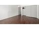 Bedroom featuring hardwood floors, neutral paint, and a closet with folding doors at 611 E Colgate Dr, Tempe, AZ 85283