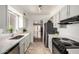 Stylish kitchen with bright white cabinets, modern appliances, and ample counter space at 611 E Colgate Dr, Tempe, AZ 85283