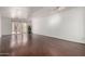 Spacious living room with sliding glass doors to the outside patio, hardwood floors and white walls at 611 E Colgate Dr, Tempe, AZ 85283