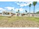 Expansive backyard showcasing a lawn, desert landscaping, a pool, and an outdoor kitchen area at 6215 E Surrey Ave, Scottsdale, AZ 85254
