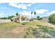 Large backyard with lawn, desert landscaping, and a covered outdoor kitchen at 6215 E Surrey Ave, Scottsdale, AZ 85254