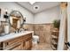 Stylish bathroom showcasing a vanity, framed mirror with sconces, and a tiled shower at 6215 E Surrey Ave, Scottsdale, AZ 85254