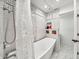 Bathroom featuring a soaking tub, shower, and white subway tile at 6215 E Surrey Ave, Scottsdale, AZ 85254