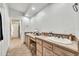 Bright bathroom featuring dual sinks, tiled vanity, and ample counter space at 6215 E Surrey Ave, Scottsdale, AZ 85254