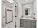 Bathroom with a modern vanity, stylish mirror, and a separate room with a linen cabinet at 6215 E Surrey Ave, Scottsdale, AZ 85254