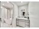 Well-lit bathroom featuring a soaking tub, modern vanity, and a stylish, illuminated mirror at 6215 E Surrey Ave, Scottsdale, AZ 85254