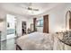 Bright bedroom with an ensuite bathroom and a walk-in closet features a ceiling fan at 6215 E Surrey Ave, Scottsdale, AZ 85254