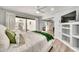 Spacious bedroom with built-in shelves, large sliding glass doors, and a view to an outdoor dining area at 6215 E Surrey Ave, Scottsdale, AZ 85254
