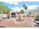 Beautiful courtyard with a fountain, lush greenery, potted plants, and comfortable outdoor seating at 6215 E Surrey Ave, Scottsdale, AZ 85254