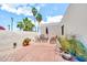 Serene courtyard featuring palm trees, flowering plants, and stylish outdoor furniture at 6215 E Surrey Ave, Scottsdale, AZ 85254