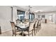 Elegant dining room featuring a decorative chandelier and large windows with access to an outdoor area at 6215 E Surrey Ave, Scottsdale, AZ 85254