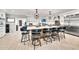 Bright kitchen with a spacious island, seating for several, modern appliances, and stylish design elements at 6215 E Surrey Ave, Scottsdale, AZ 85254