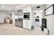 Bright kitchen space with stainless steel appliances, a large refrigerator, and a view into the laundry room at 6215 E Surrey Ave, Scottsdale, AZ 85254