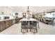 Open concept kitchen with a large island, seating, stainless steel appliances, and direct view of the dining area at 6215 E Surrey Ave, Scottsdale, AZ 85254