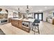 Spacious kitchen featuring a large island with seating, stainless steel appliances, and elegant light fixtures at 6215 E Surrey Ave, Scottsdale, AZ 85254