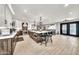 Expansive kitchen with a center island, seating, modern appliances, and seamless transition to the dining area at 6215 E Surrey Ave, Scottsdale, AZ 85254