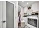Functional laundry room equipped with modern appliances and plenty of storage space at 6215 E Surrey Ave, Scottsdale, AZ 85254