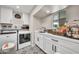 Well-organized laundry room featuring a sink, ample counter space, and modern appliances at 6215 E Surrey Ave, Scottsdale, AZ 85254