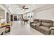 Spacious living room with tile floors, recessed lighting, ceiling fan, and comfortable seating near a game table at 6215 E Surrey Ave, Scottsdale, AZ 85254