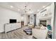 Bright living room features a fireplace, modern furnishings, and a stylish chandelier at 6215 E Surrey Ave, Scottsdale, AZ 85254