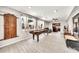 Inviting living room featuring wood-look tile floors, recessed lights, and abundant natural light through large windows at 6215 E Surrey Ave, Scottsdale, AZ 85254