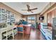 Organized home office with a ceiling fan, wood floors, window, and ample storage space at 6215 E Surrey Ave, Scottsdale, AZ 85254