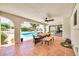 An outdoor patio with dining area overlooks the sparkling backyard pool and manicured lawn at 6215 E Surrey Ave, Scottsdale, AZ 85254