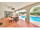 An outdoor dining area is adjacent to the pool and manicured backyard at 6215 E Surrey Ave, Scottsdale, AZ 85254