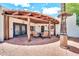Inviting covered patio with an outdoor television, a ceiling fan, and cozy seating area at 6215 E Surrey Ave, Scottsdale, AZ 85254
