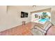 Comfortable covered patio with tile flooring and views of the pool at 6215 E Surrey Ave, Scottsdale, AZ 85254
